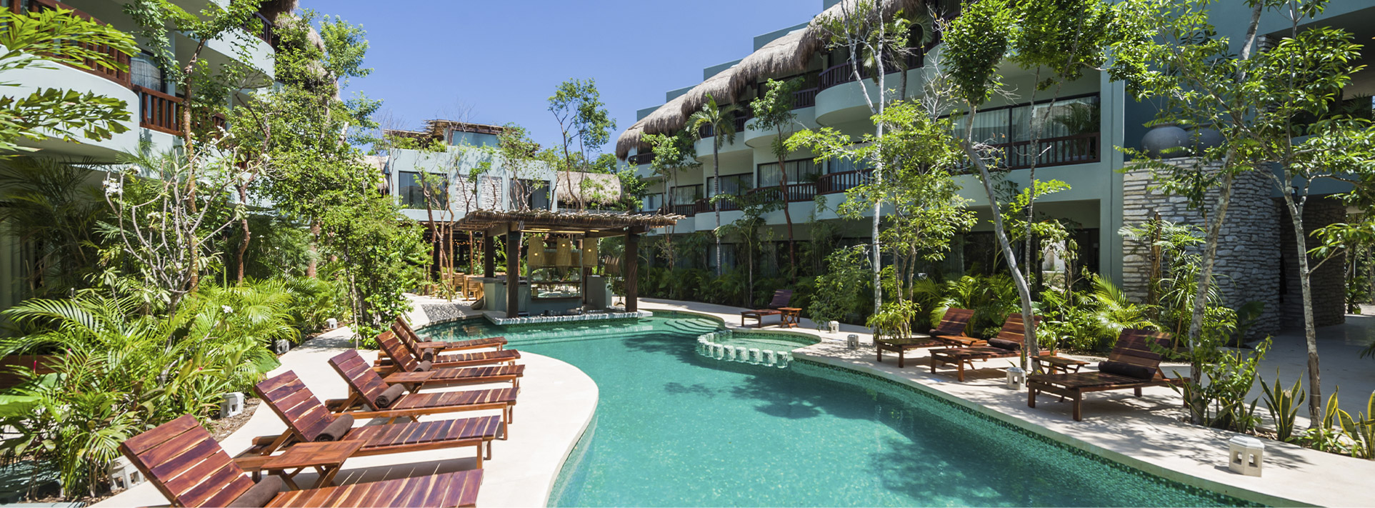 Kimpton Aluna Resort Tulum boutique hotel with modern bohemian design, lush gardens, rooftop pool, and European Plan lodging in Tulum.