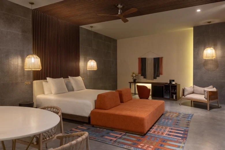 Preferred Club Master Suite Swim Out with king bed, spacious sitting area, and modern décor at Secrets Tulum Resort & Beach Club.