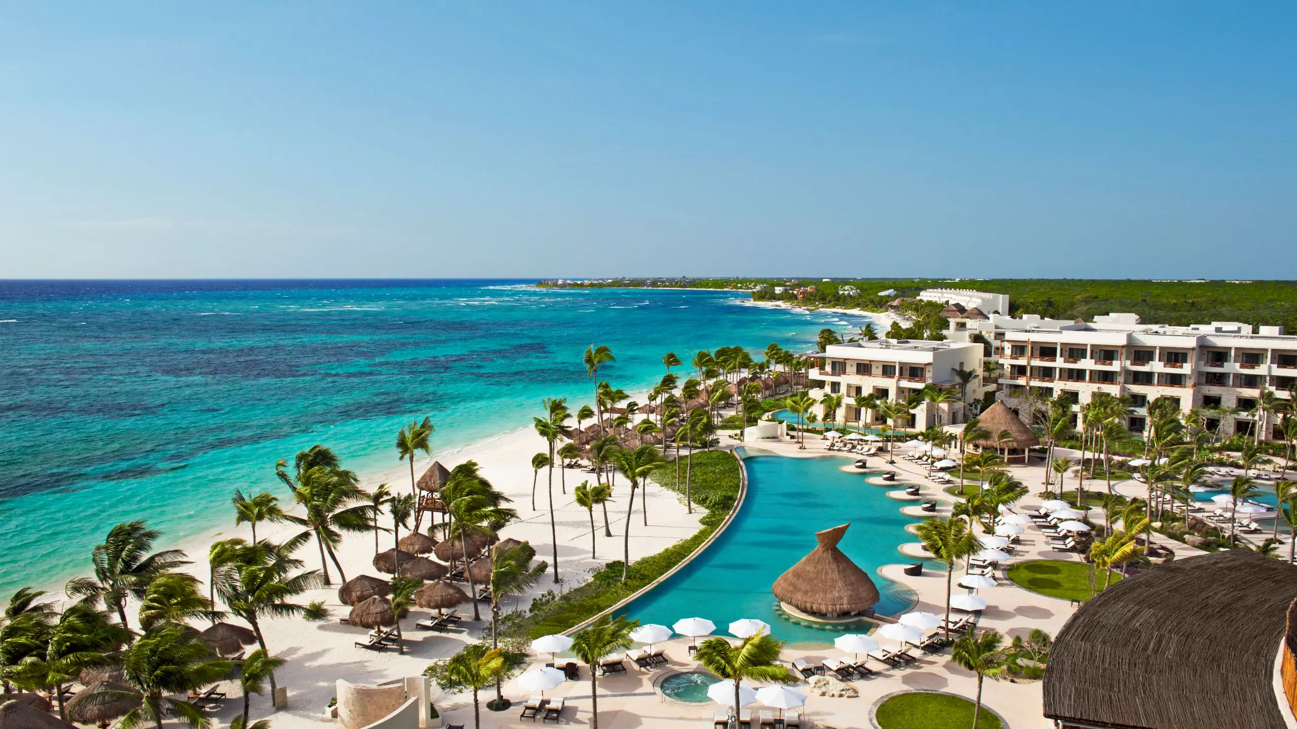 Secrets Akumal Riviera Maya adults-only all-inclusive resort with beachfront pools, lush tropical grounds, and a calm Akumal Bay setting.